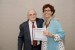 Dr. Nagib Callaos, General Chair, giving Prof. Gabriela E. Vilanova the best paper award certificate of the session "Educación, Cibernética e Informática." The title of the awarded paper is "Innovación en Procesos de Enseñanza Aprendizaje en Entornos Virtuales."